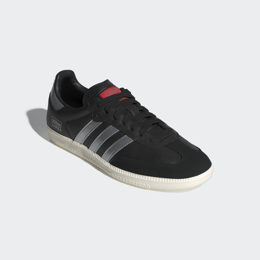 black adidas with silver stripes